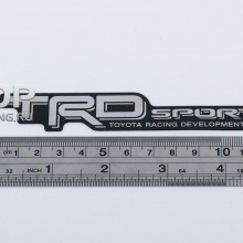 Никелевая эмблема - Модель TRD Sport - Тюнинг Тойота. Размер 120 * 21мм.