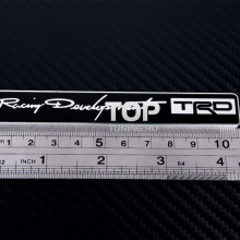 Алюминиевая эмблема TRD (Toyota Racing Development), черного цвета, с зеркальными буквами. Размер 110 * 17 мм.