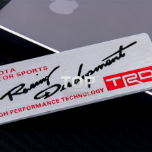 Эмблема на клеевой основе - TRD Hight Performance Technology - Серебристая, горизонтальная шлифовка. Размер 80 * 30 мм.
